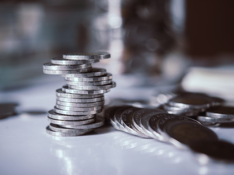 bottles-cash-with-coins-saving-money-concept