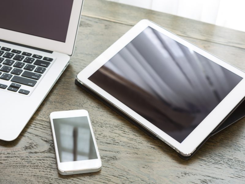 close-up-technological-devices-wooden-desk
